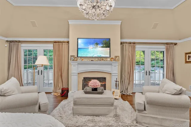 a living room with furniture a fireplace and a flat screen tv