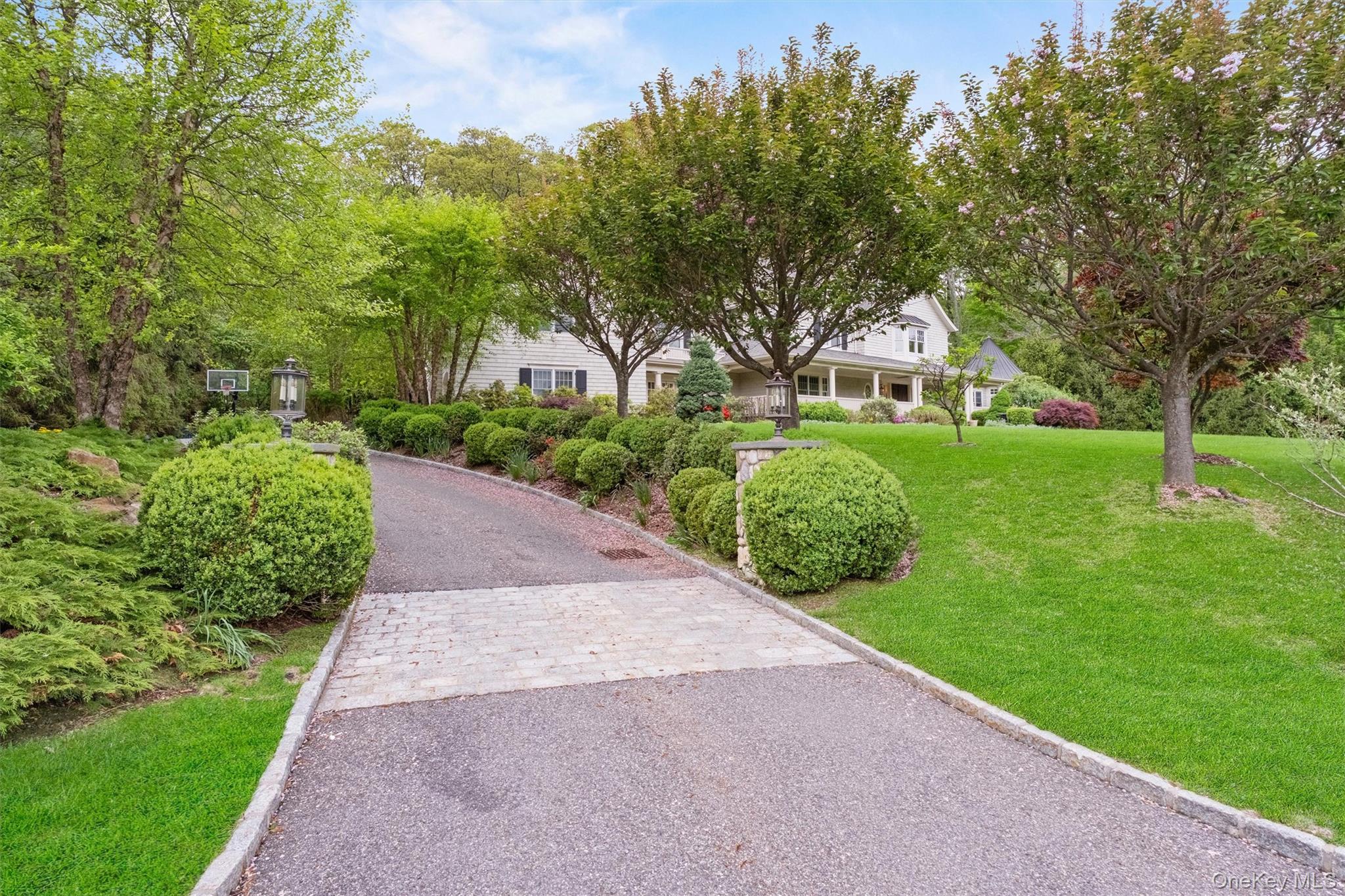 7 Ridgeview Circle Armonk, NY 10504 - Photo 31 of 35 a front view of a house with a yard and shrubs