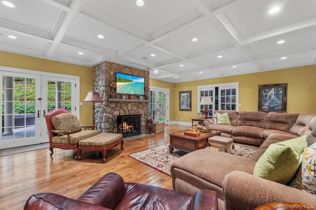 a living room with furniture fireplace and a large window