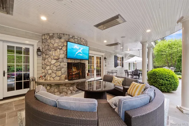 a living room with fireplace furniture and a flat screen tv