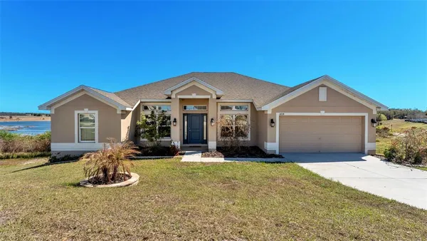 a front view of a house with a yard and garage
