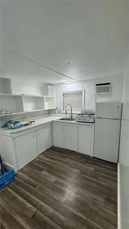 a kitchen with a sink cabinets and stainless steel appliances