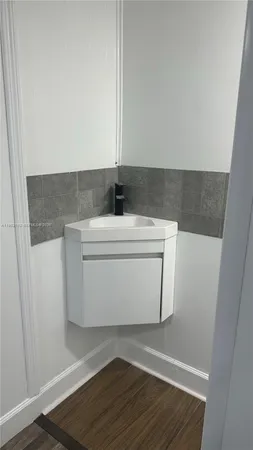 a utility room with wooden floor washer and dryer