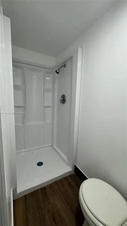 a bathroom with a toilet and shower