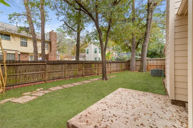 a view of a backyard with wooden fence
