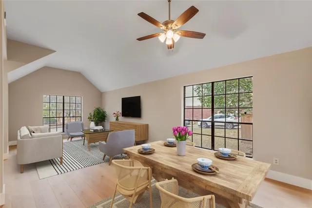 a view of a dining room with furniture a chandelier and wooden floor