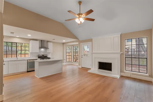 a view of open kitchen with a stove cabinets and a floor to ceiling window