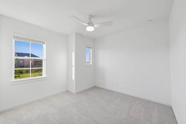 an empty room with windows and entrance