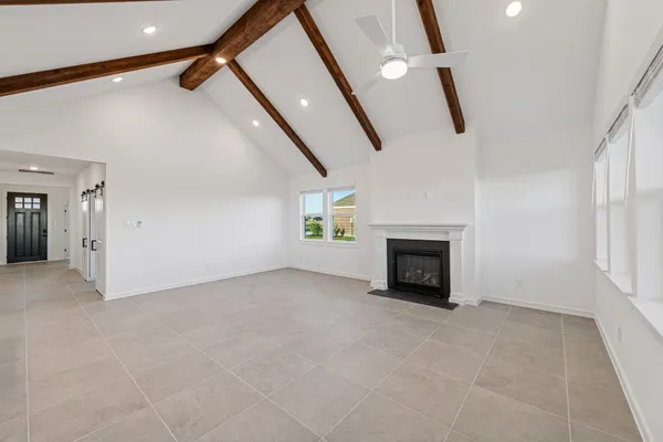 a view of empty room with fireplace and windows