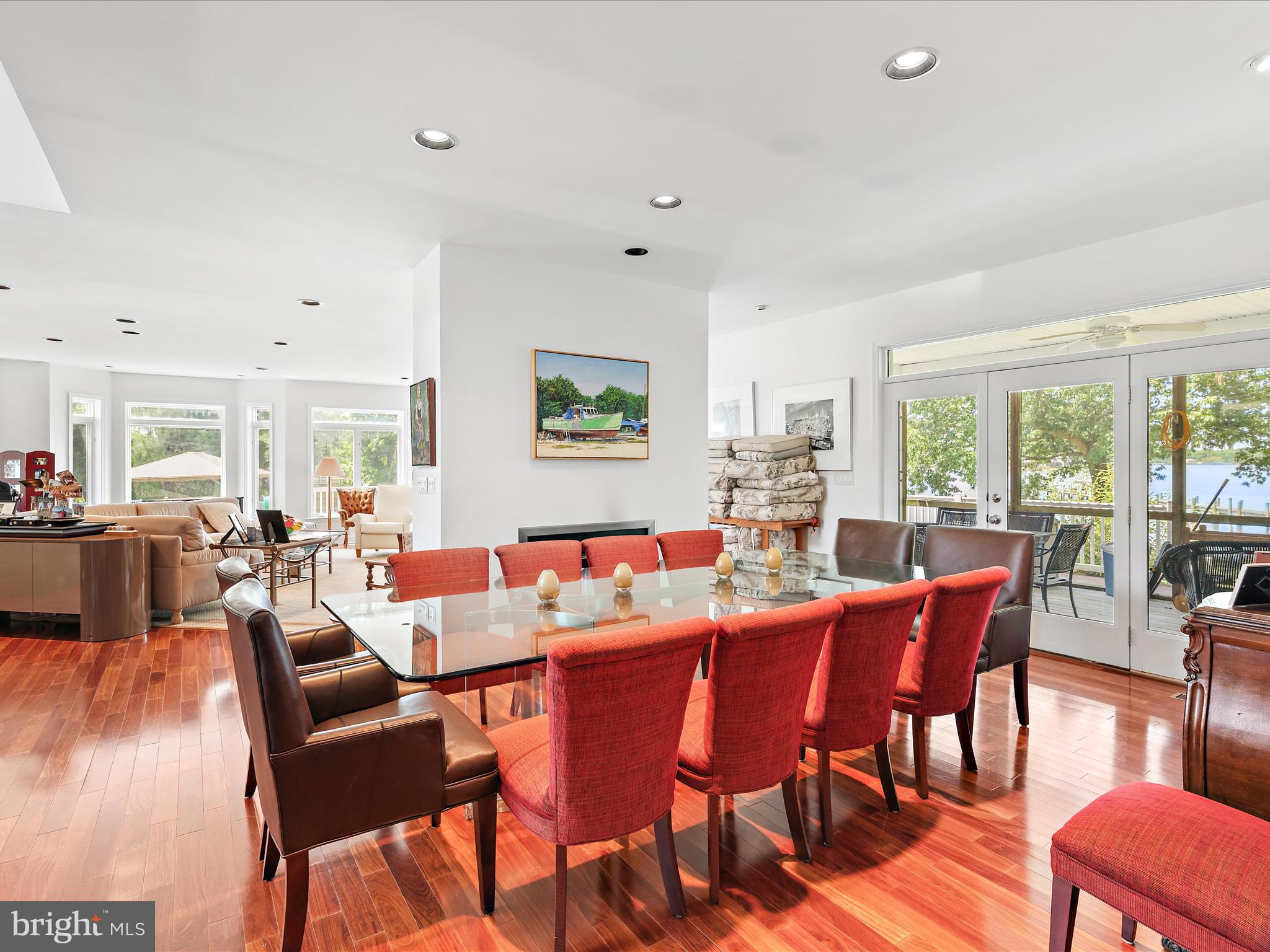 11114 Spring Branch Lane Berlin, MD 21811 - Photo 34 of 75 a dining room with furniture a large window and wooden floor