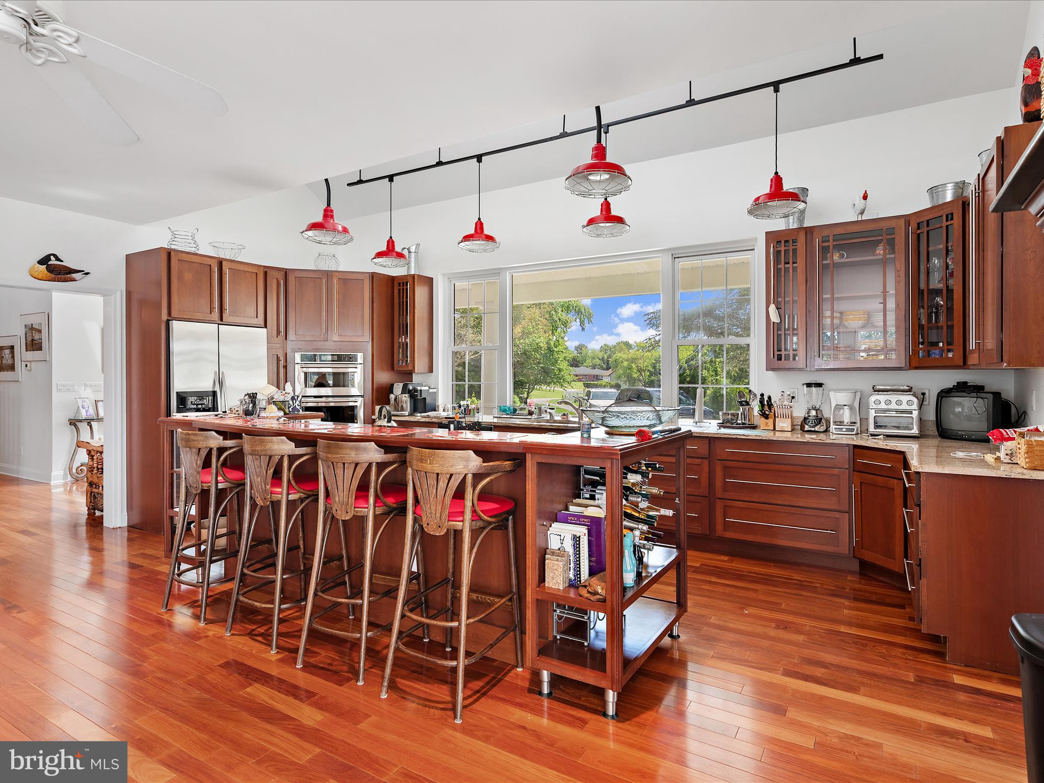 11114 Spring Branch Lane Berlin, MD 21811 - Photo 37 of 75 a kitchen with stainless steel appliances granite countertop a kitchen island hardwood floor and a sink