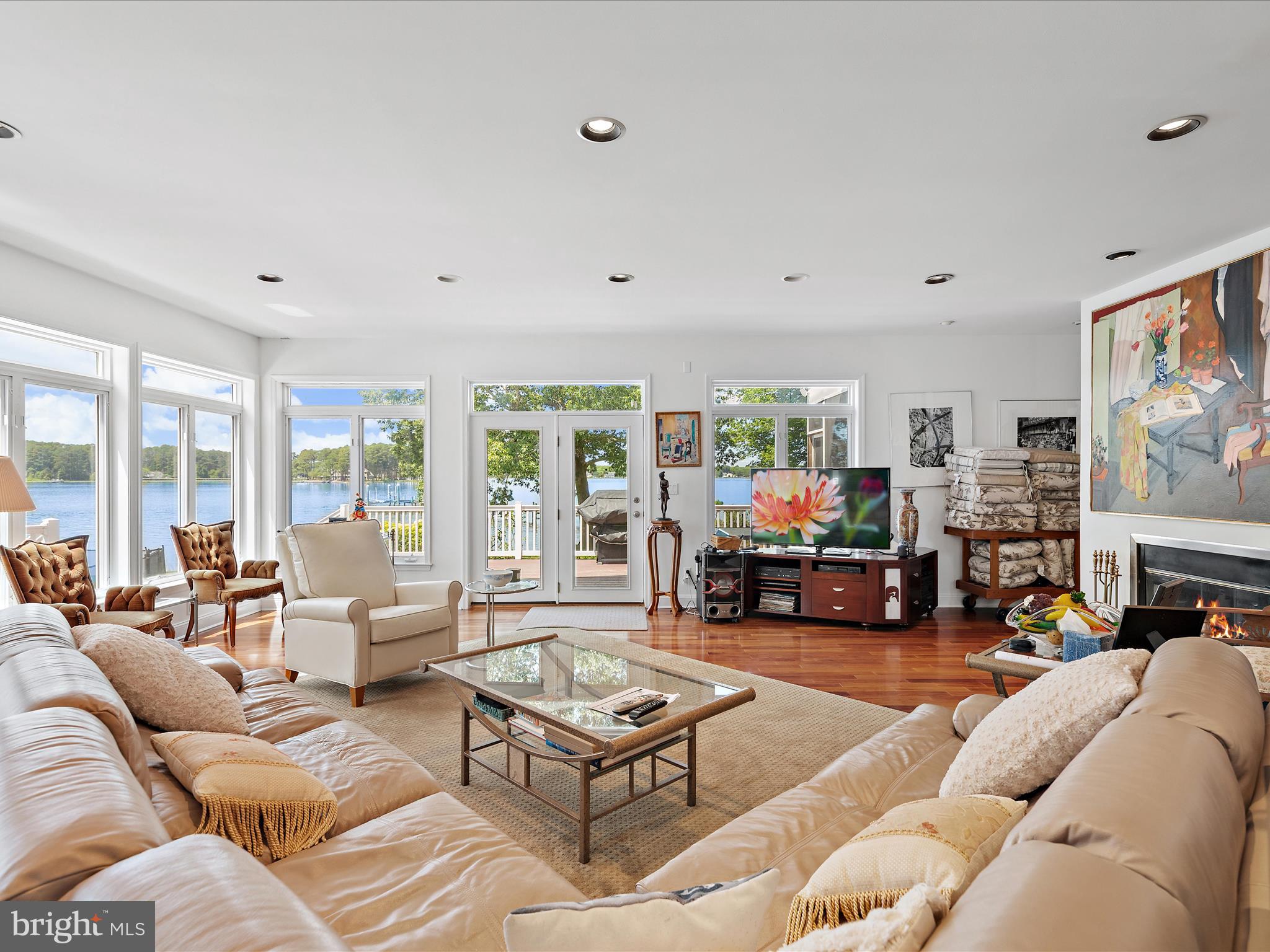 11114 Spring Branch Lane Berlin, MD 21811 - Photo 40 of 75 a living room with furniture large window and flat screen tv