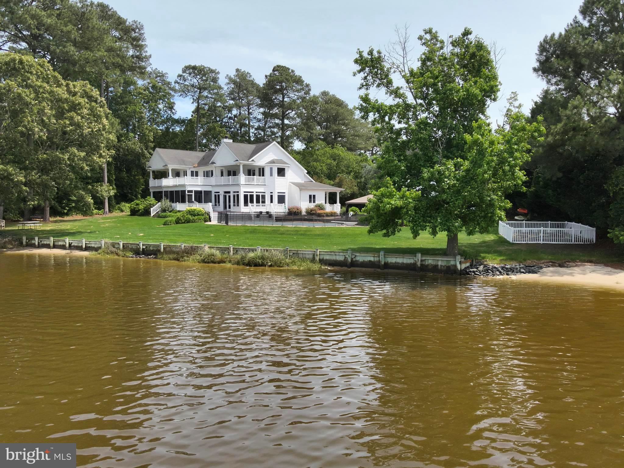 11114 Spring Branch Lane Berlin, MD 21811 - Photo 58 of 75 a view of a house next to a lake with a large trees