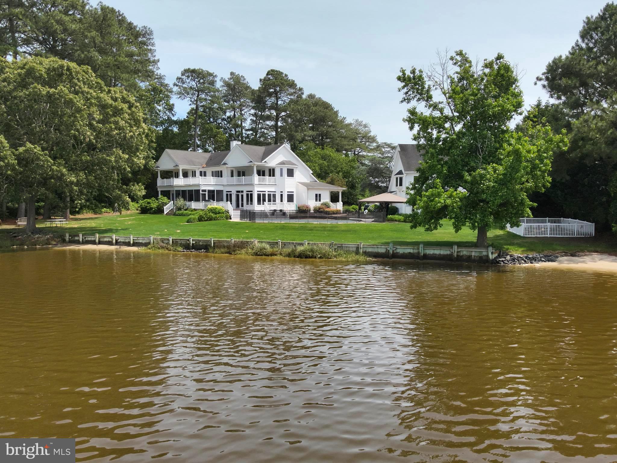 11114 Spring Branch Lane Berlin, MD 21811 - Photo 59 of 75 a view of a lake with a house in the background