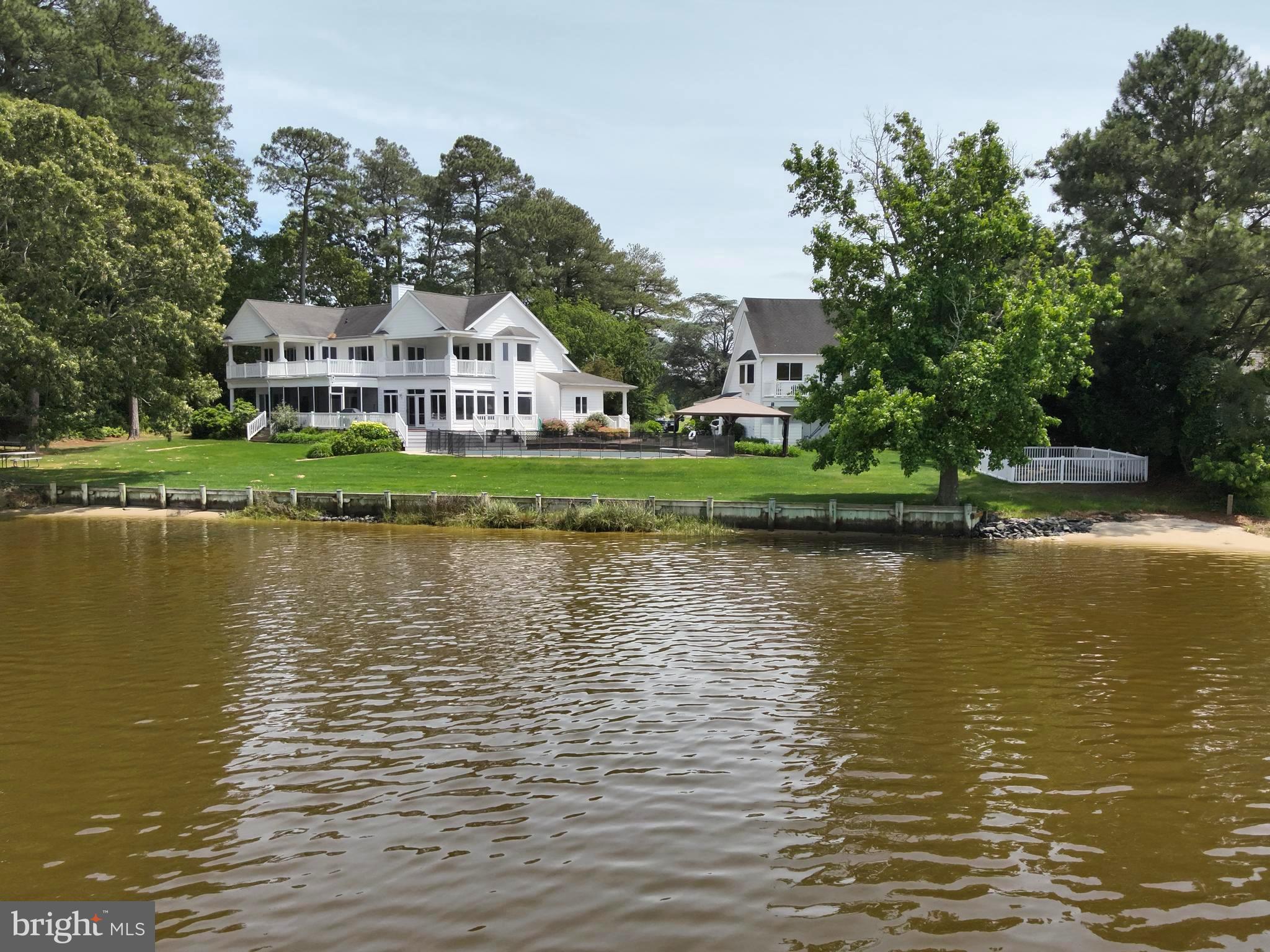 11114 Spring Branch Lane Berlin, MD 21811 - Photo 60 of 75 a view of a lake with a house in the background