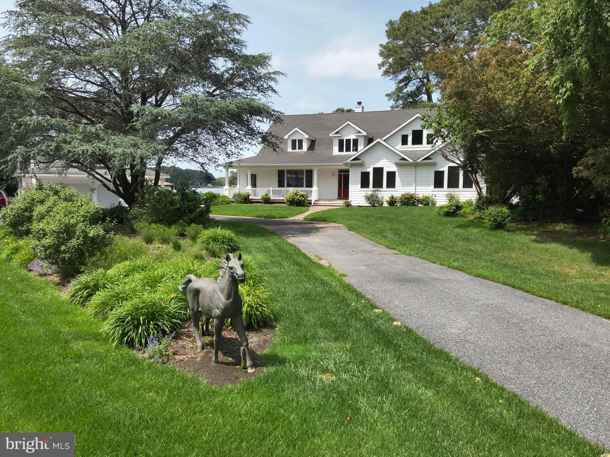 11114 Spring Branch Lane Berlin, MD 21811 - Photo 73 of 75 a front view of a house with a garden and trees