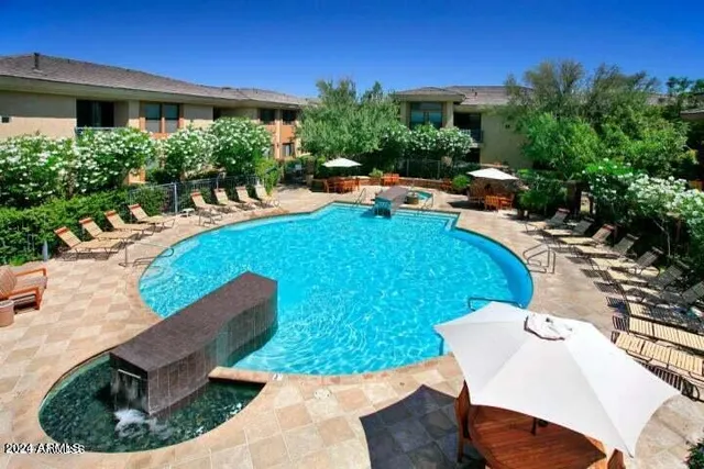 a view of a backyard with plants and patio