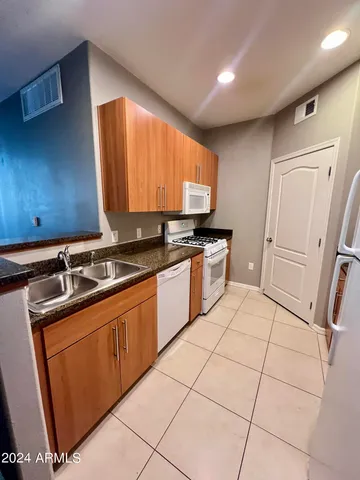 a kitchen with stainless steel appliances a sink stove and cabinets