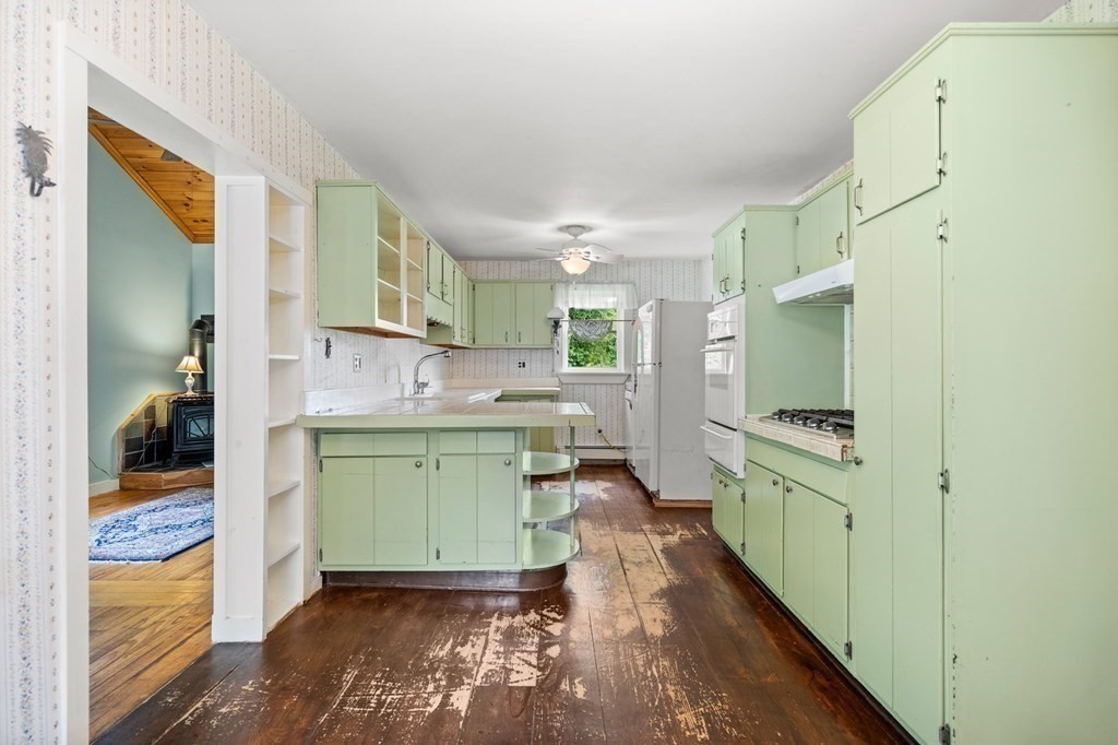 88 Swain Road North Chelmsford, MA 01863 - Photo 8 of 29 a kitchen with window cabinets and stainless steel appliances