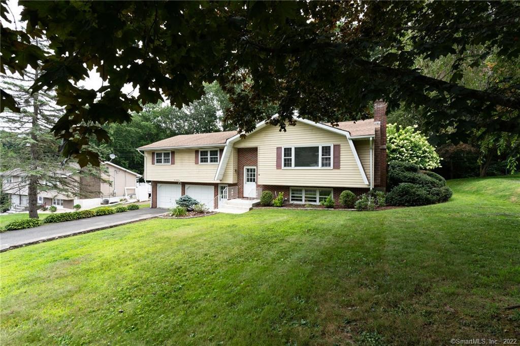 153 Stoddard Road Waterbury, CT 06708 - Photo 1 of 1 a front view of a house with a garden