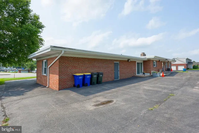 a view of a hallway with a room and wooden floor