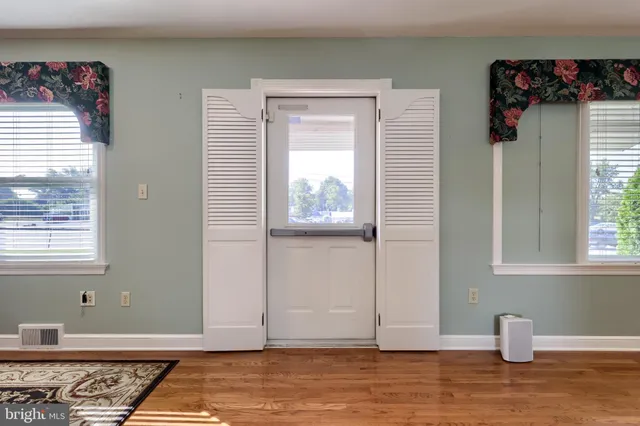 a room with a rug and a window