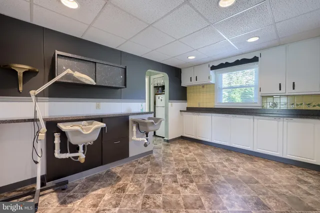 a living room with a mirror and a fireplace
