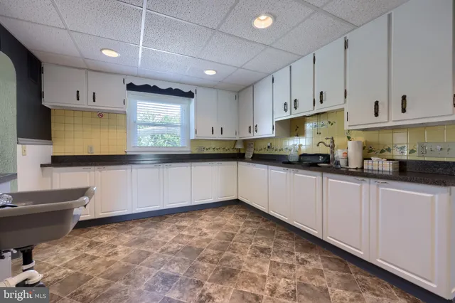 a bedroom with a bed and a mirror on the dresser