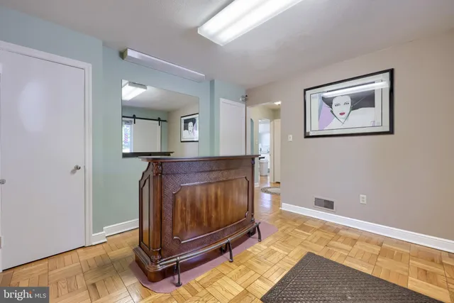 a room with a bed and a dresser