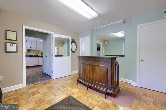 a view of a kitchen with fridge and sink