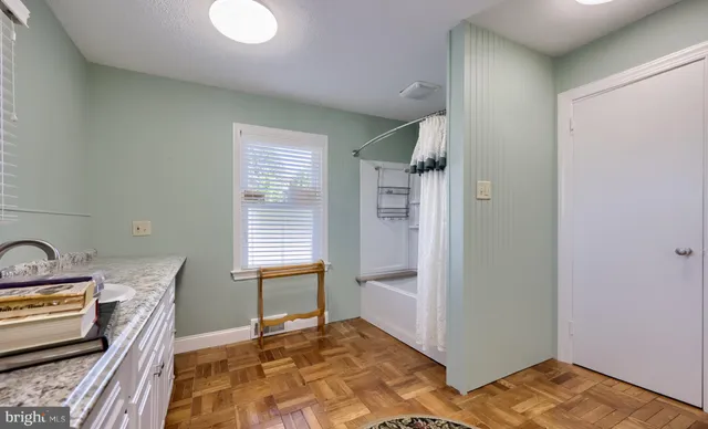 a kitchen with granite countertop a stove a sink and a refrigerator