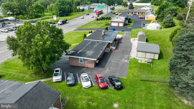 an aerial view of a house with garden space and street view