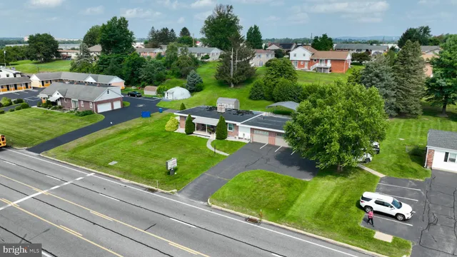 an aerial view of a house with swimming pool patio and outdoor seating