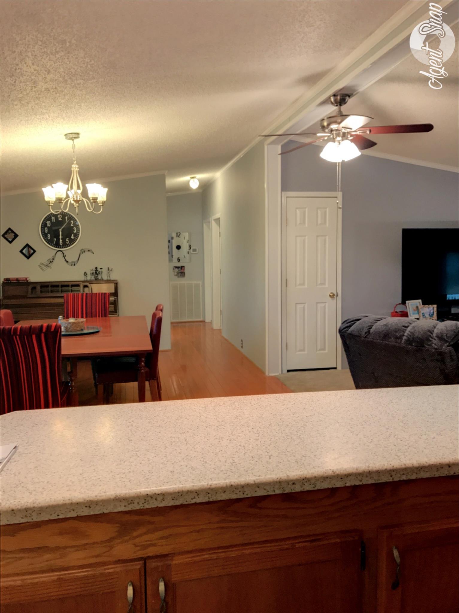 612 Lear Road Portland, TN 37148 - Photo 8 of 17 a living room with stainless steel appliances kitchen island a chandelier