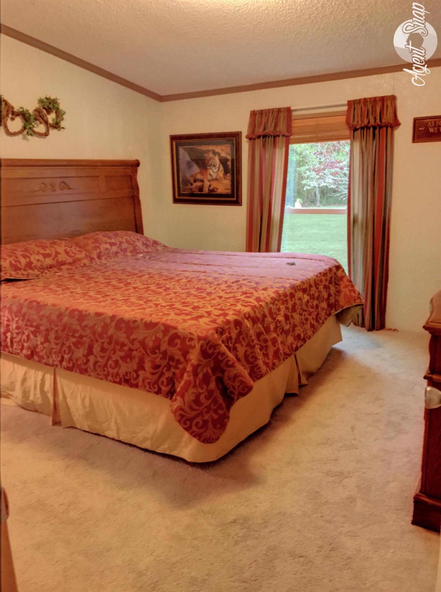 612 Lear Road Portland, TN 37148 - Photo 10 of 17 a large bed sitting in a bedroom next to a window