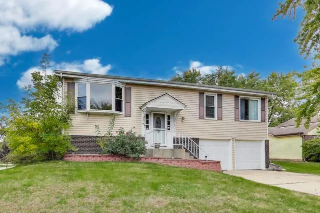 a front view of house with yard and green space