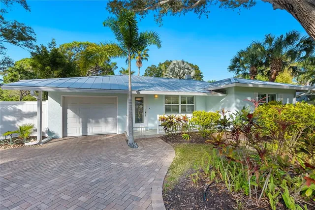 a front view of a house with a garden and patio