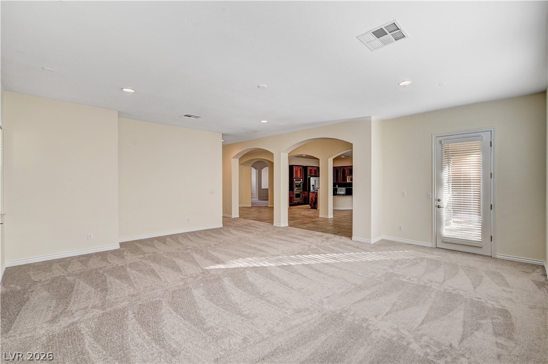 6761 Clay TABLET Street Las Vegas, NV 89149 - Photo 14 of 73 An open living space features plush neutral carpeting, smooth plaster walls, and classic arched transitions.