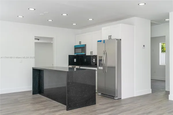 a kitchen with granite countertop a sink and a stove