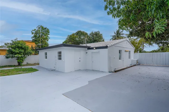 a view of a house with a backyard and a garage