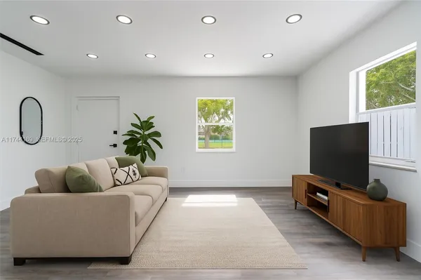 a living room with furniture and a flat screen tv