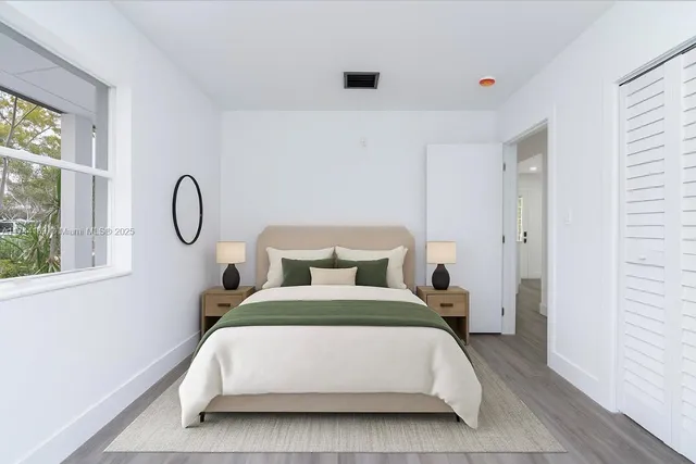 a bedroom with bed and a window