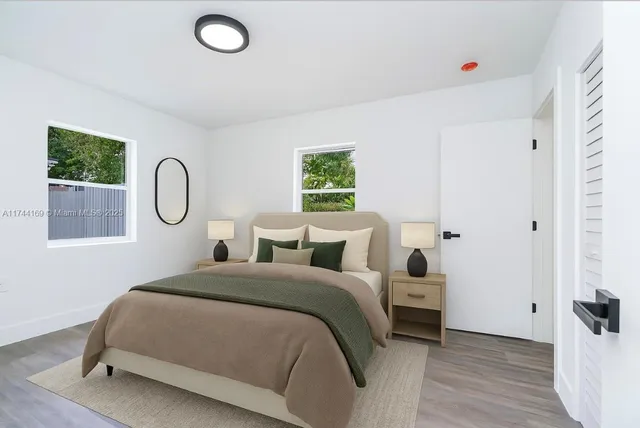 a bedroom with bed and a window