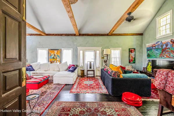 a living room with furniture and a floor to ceiling window