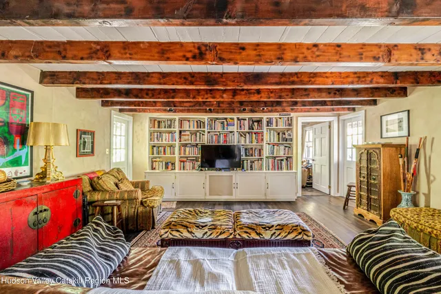 a room with lots of wooden furniture and a chandelier