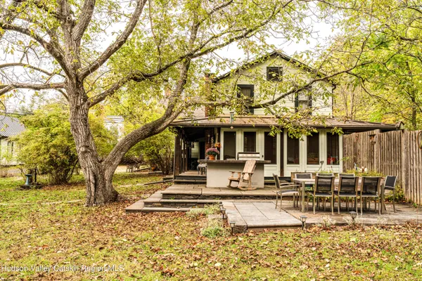 a view of a house with backyard porch and sitting area