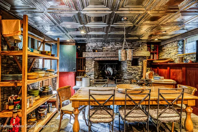 a dining room with furniture and a floor to ceiling window