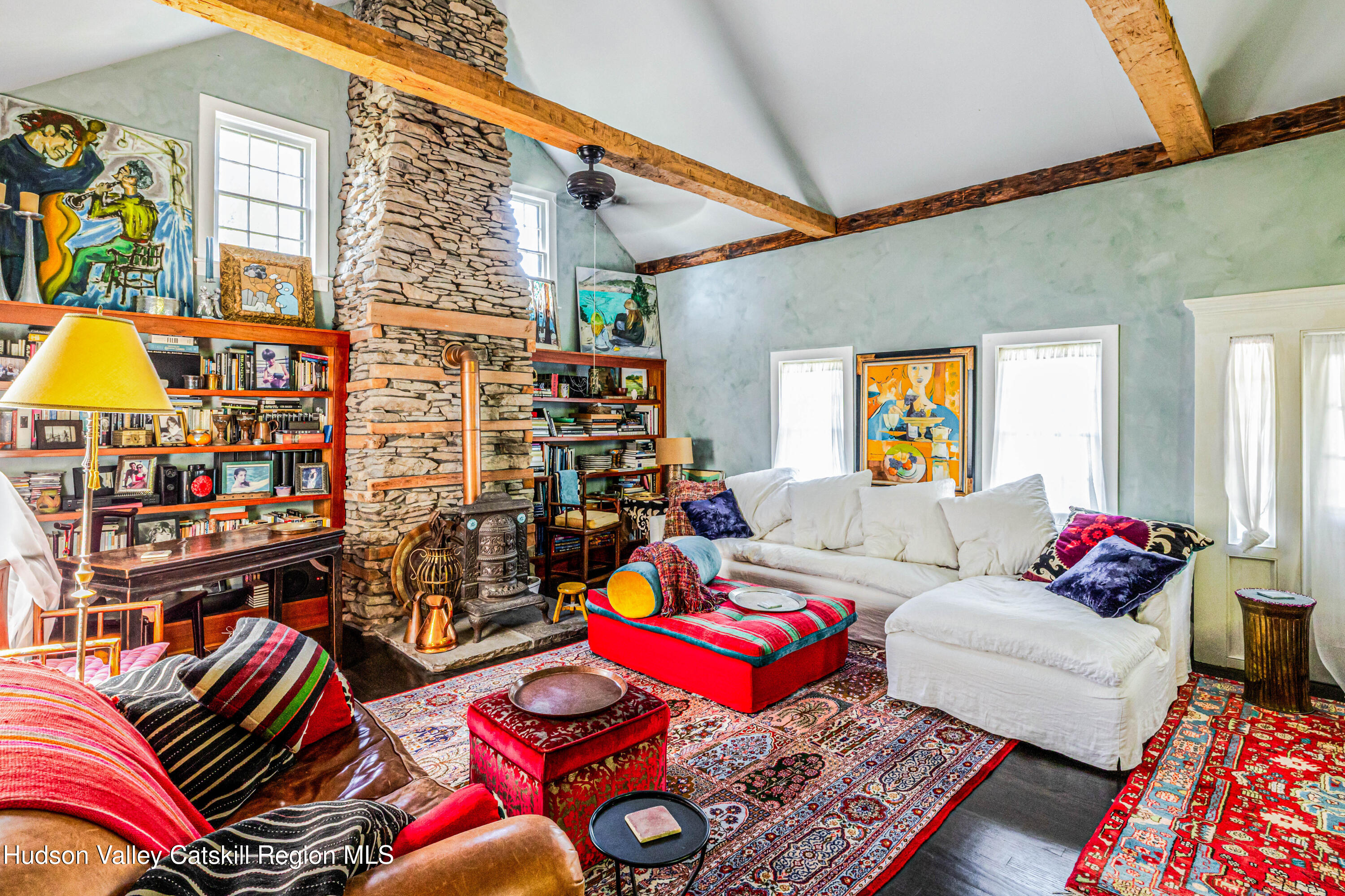 1 Wittenberg Road Bearsville, NY 12409 - Photo 36 of 72 a living room filled with furniture and a book shelf