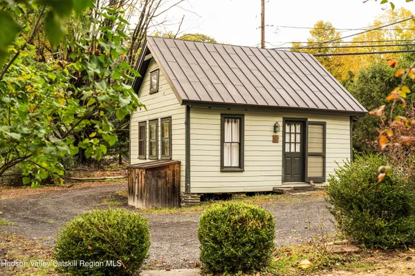 a front view of a house with a garden