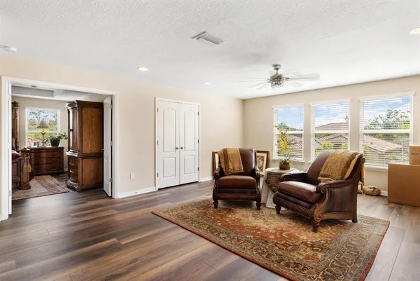 a living room with furniture rug and wooden floor